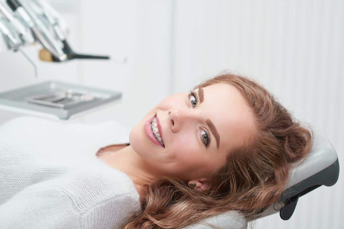 Happy,Young,Ginger,Haired,Woman,With,Braces,Smiling,To,The What Do Braces Feel Like