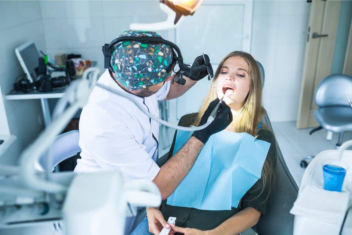 A patient operating with an implants dentist for tooth replacement