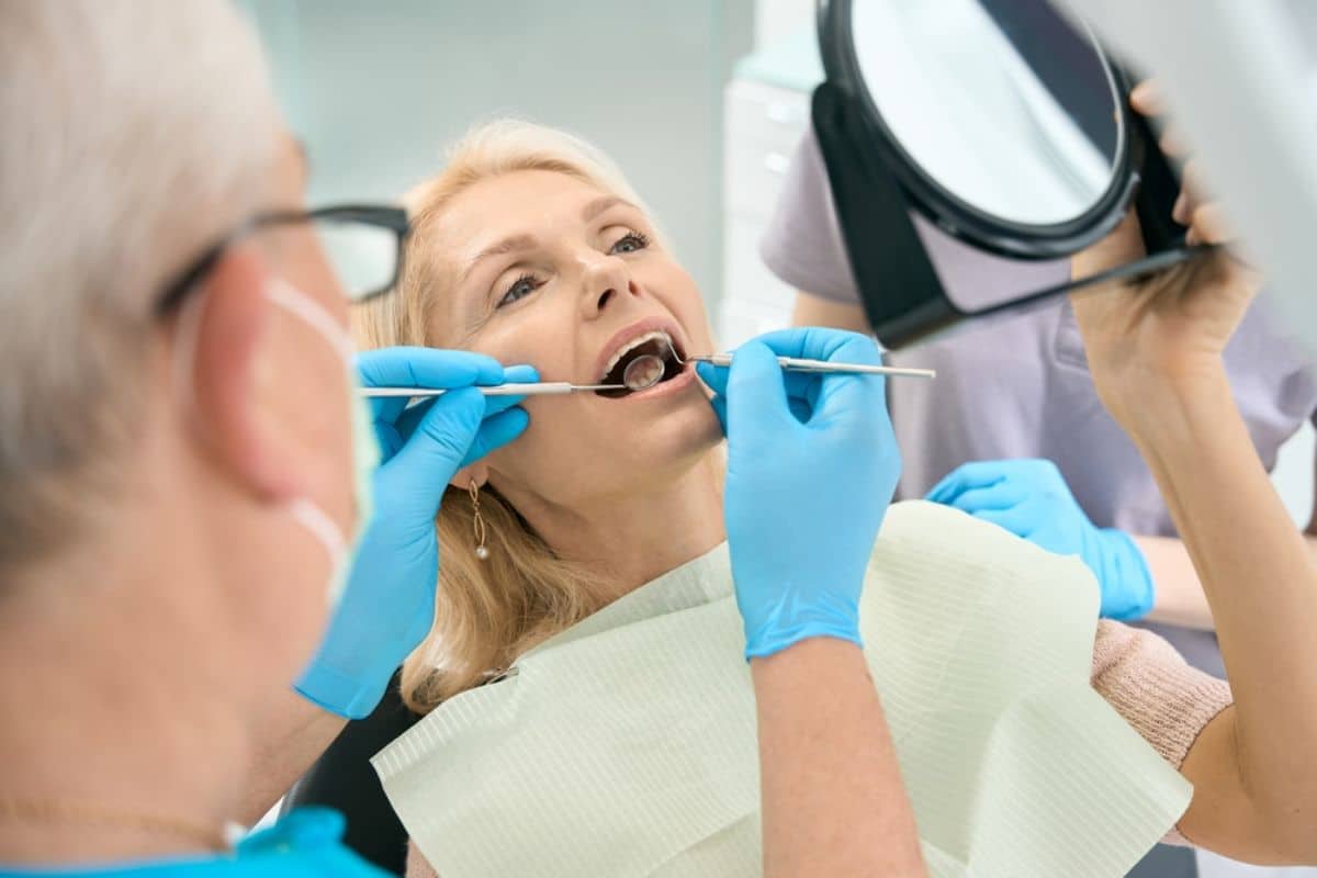 A patient receiving a professional dental check-up A patient receiving a professional dental check-up from a dentist.