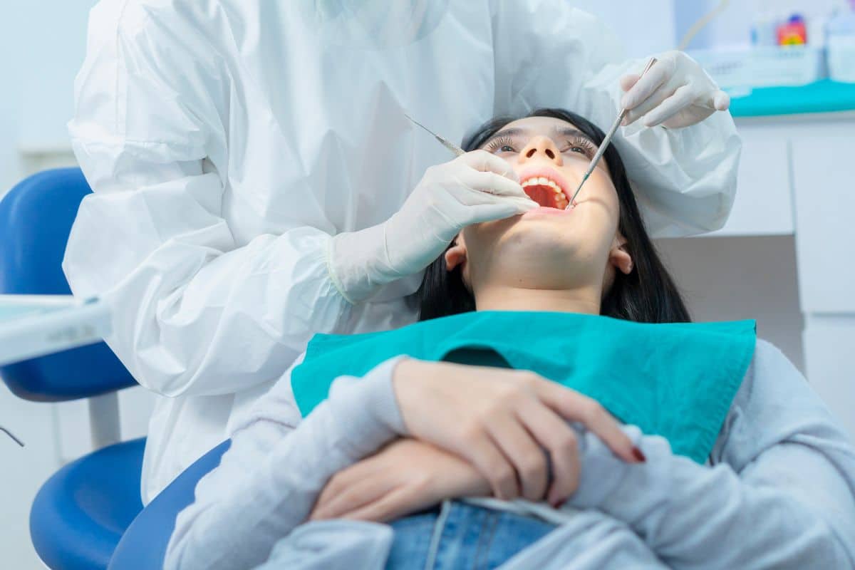 Patient receiving dental exam Patient receiving dental exam from a dentist in Rio Rancho clinic.
