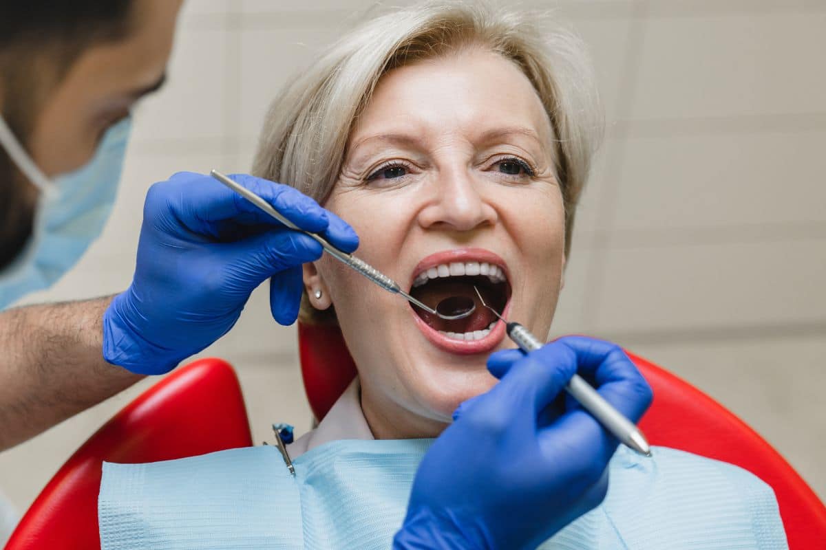 Dentist examining a patient teeth Patient receiving a dental checkup from a dentist in Rio Rancho.