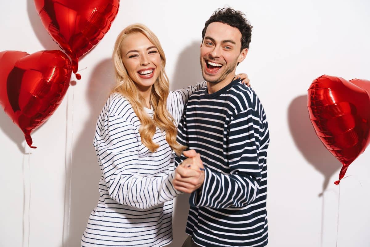 Valentines Day Couple smiling confidently on Valentine's Day with healthy white teeth.