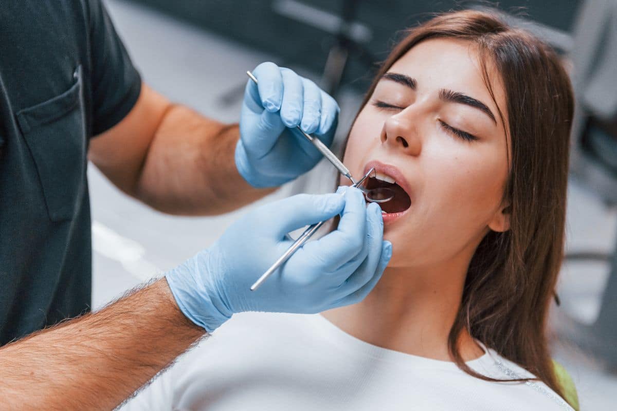 A patient receiving a dental checkup before a cosmetic dental procedure.