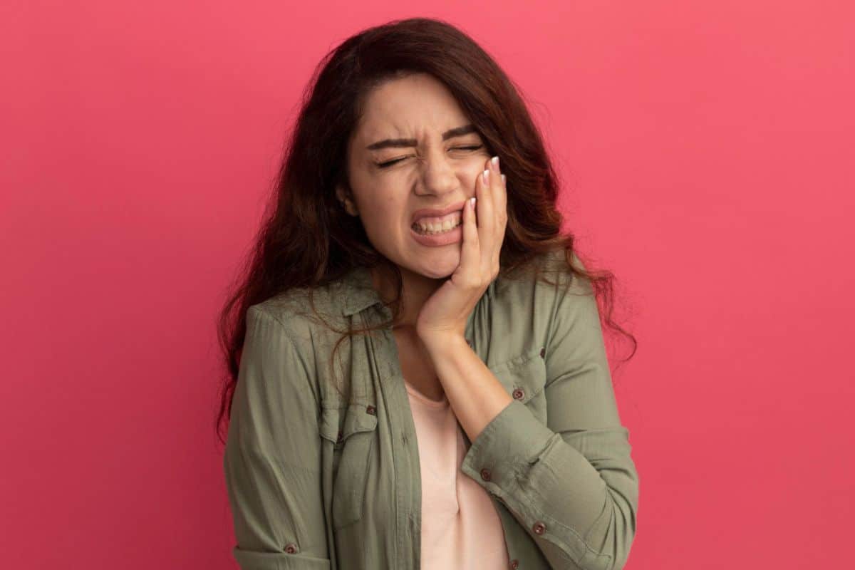 Tooth Pain Woman experiencing tooth pain after a chipped tooth and seeking emergency dental care.