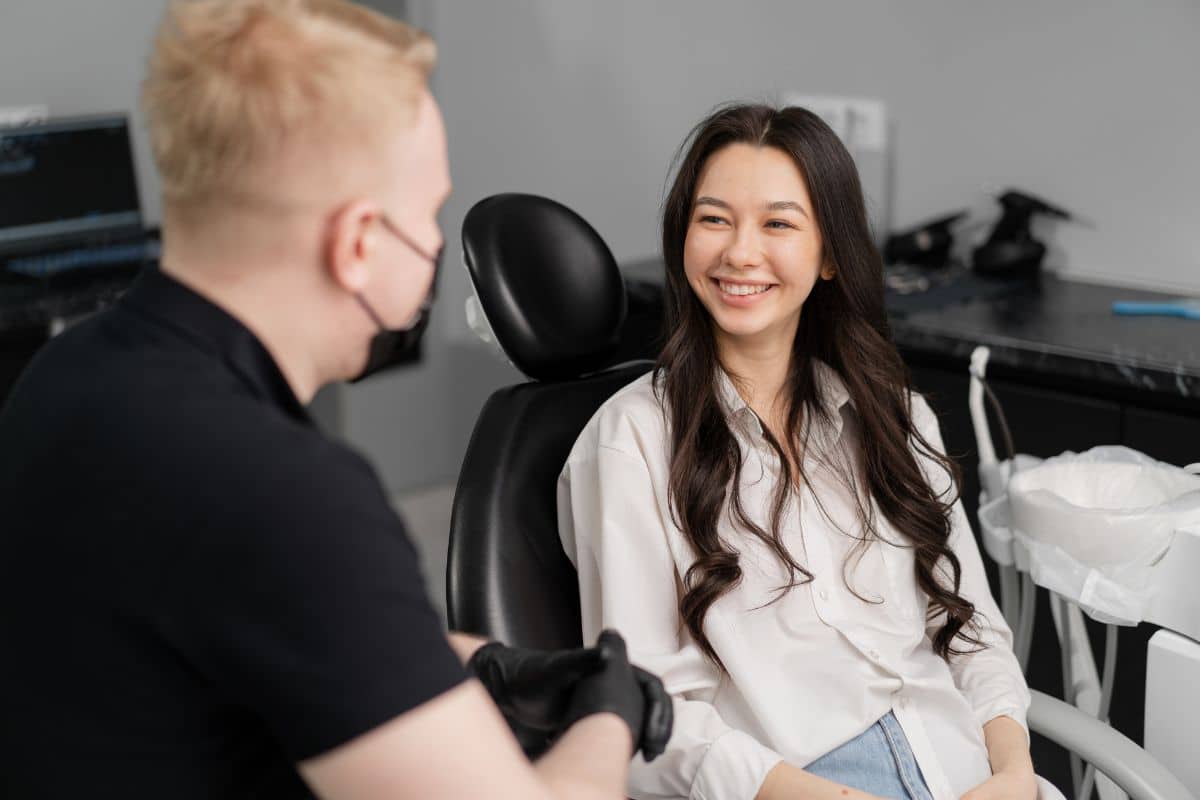 Patient discussing oral health concerns with a dentist during an early cavity evaluation.